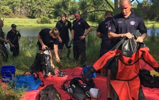 Firefighters putting on scuba diving equipment