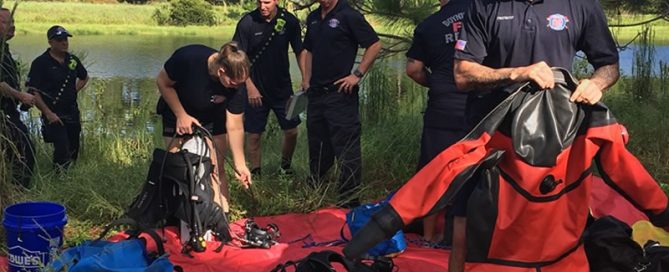 Firefighters putting on scuba diving equipment