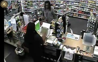 black man using stolen credit card at cash register