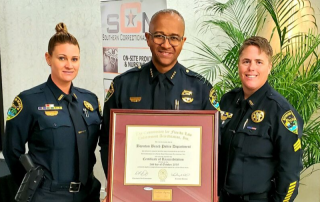 Chief Gregory holding framed certificate