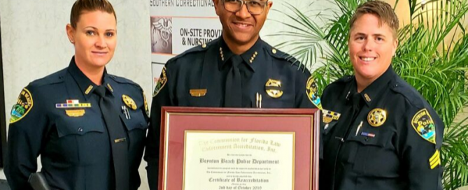 Chief Gregory holding framed certificate