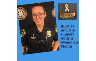 Police officer wearing a pin to support autism awareness month