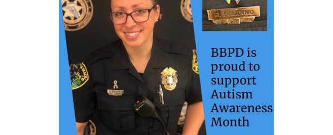 Police officer wearing a pin to support autism awareness month