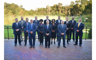 Group of men and women standing together and smiling