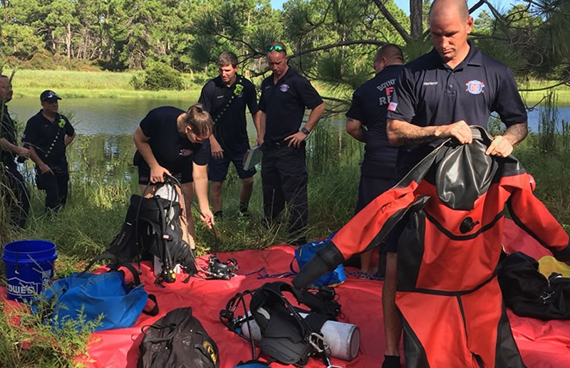 Firefighters putting on scuba diving equipment