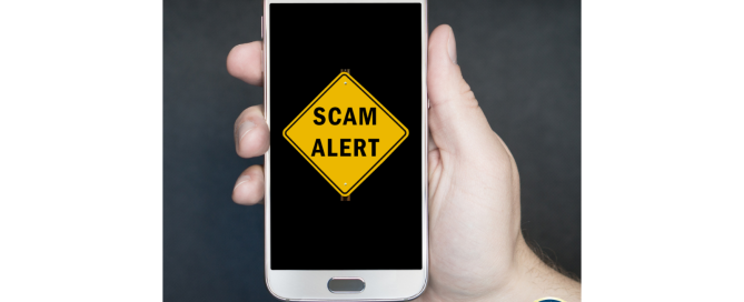 Person holding cell phone announcing scam alert